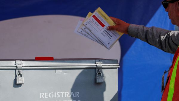 An election worker places mail-in ballots into an election box at a drive-through drop off location at the Registrar of Voters in San Diego, California, U.S. November 5, 2018. An election worker places mail-in ballots into an election box at a drive-through drop off location at the Registrar of Voters in San Diego, California, U.S. November 5, 2018. - Sputnik International