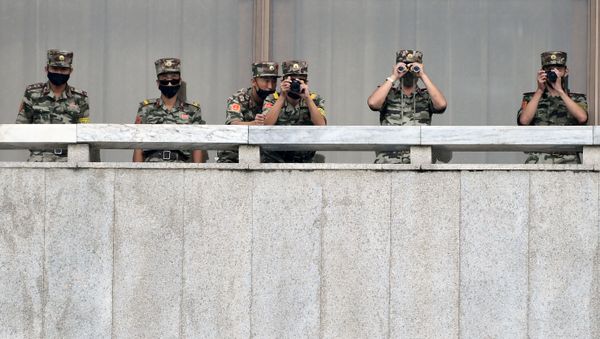 North Korean soldiers keep watch toward the south as South Korean Unification Minister Lee In-young inspects (not pictured) the truce village of Panmunjom inside the demilitarised zone separating the two Koreas, South Korea, 16 September 2020. - Sputnik International