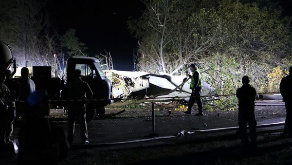 Rescuers inspect wreckages of the Ukrainian military Antonov An-26 plane after crashing outside of Chuhuiv town, Ukraine, September 25, 2020 - Sputnik International
