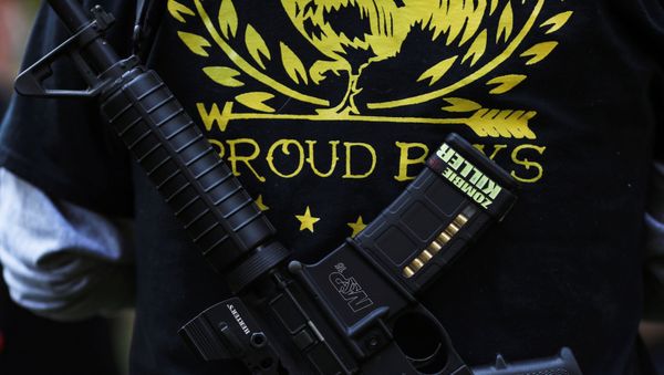A Proud Boy carries a gun during a gathering at a local park to remember Patriot Prayer supporter Aaron J. Danielson, who was shot dead in Portland, Oregon after street clashes between supporters of President Donald Trump and counter-demonstrators, in Vancouver, Washington, U.S. September 5, 2020. - Sputnik International