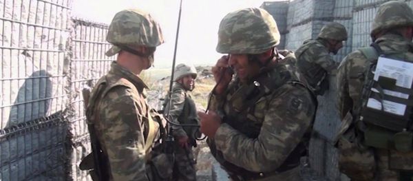 In this handout video grab released by the Azerbaijan Defence Ministry, Azeri military personnel conduct military operations in self-proclaimed Republic of Artsakh, Nagorno-Karabakh, Azerbaijan. On September 27 clashes erupted between Armenian and Azeri forces along the line of contact in the disputed region of Nagorno-Karabakh - Sputnik International