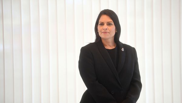 Britain's Home Secretary Priti Patel looks on ahead of a minute's silence inside the atrium at Scotland Yard in London on September 25, 2020, following the shooting of a British police officer by a 23-year-old man being detained at the centre. - Sputnik International