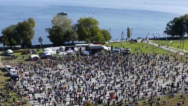 A general view taken from a wheel shows people gathering during a protest against the government's restrictions, amid the coronavirus disease (COVID-19) outbreak, in Konstanz, Germany October 4, 2020 A general view taken from a wheel shows people gathering during a protest against the government's restrictions, amid the coronavirus disease (COVID-19) outbreak, in Konstanz, Germany October 4, 2020 - Sputnik International