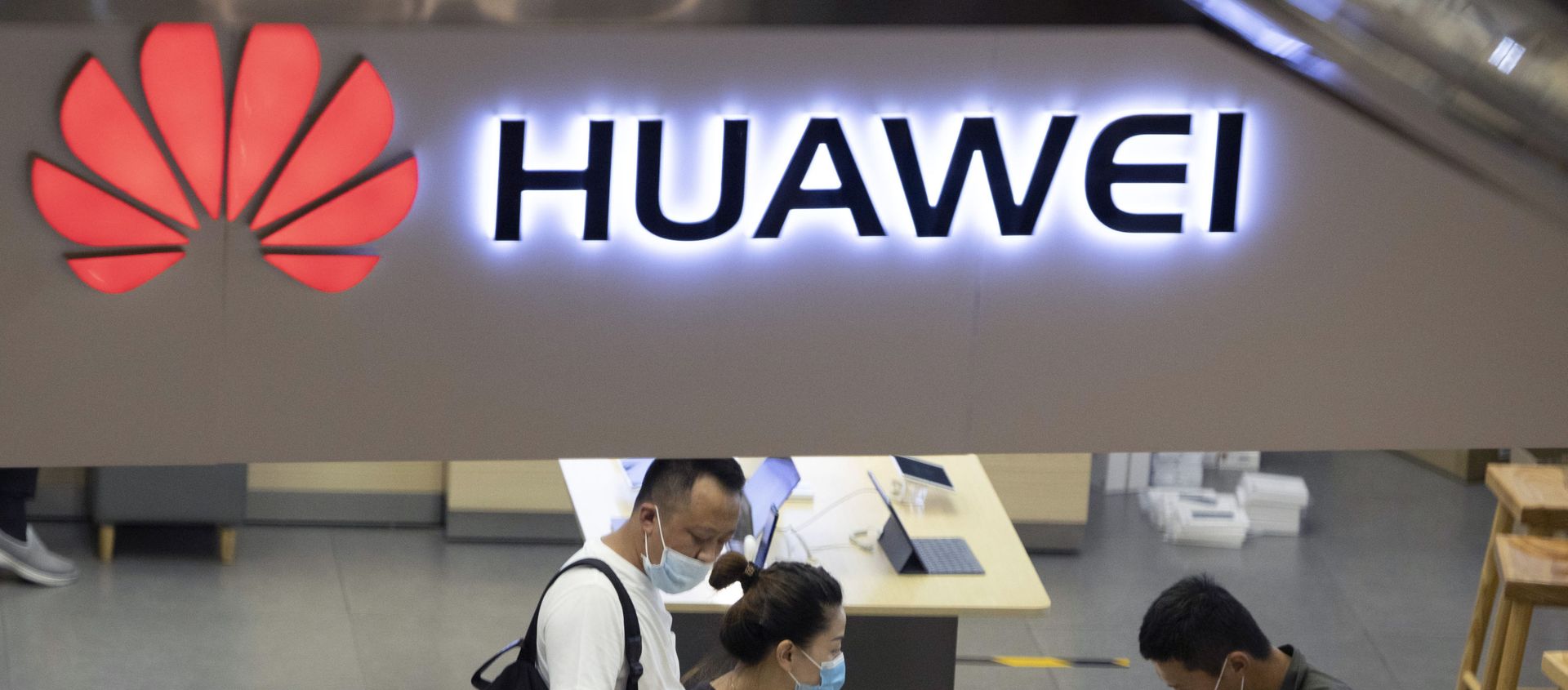 In this July 15, 2020, file photo, visitors wearing masks to curb the spread of the coronavirus look at the latest products at a Huawei store in Beijing. China accused Washington of damaging global trade with sanctions that threaten to cripple tech giant Huawei and said Tuesday it will protect Chinese companies but gave no indication of possible retaliation In this July 15, 2020, file photo, visitors wearing masks to curb the spread of the coronavirus look at the latest products at a Huawei store in Beijing. China accused Washington of damaging global trade with sanctions that threaten to cripple tech giant Huawei and said Tuesday it will protect Chinese companies but gave no indication of possible retaliation - Sputnik International, 1920, 02.03.2021