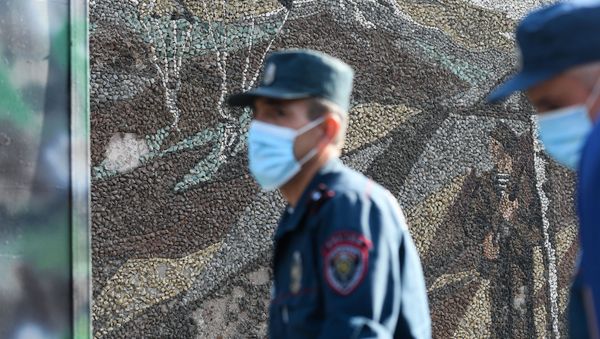 Armenian police officers wearing face masks to protect against the coronavirus disease patrol in front of a military commissariat in Yerevan on September 30, 2020 - Sputnik International