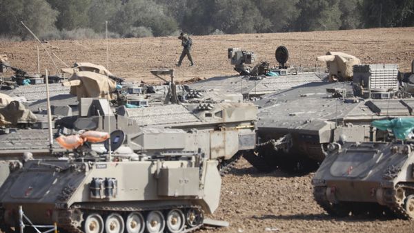 An Israeli soldier walks past military vehicles in a gathering point near the Israel-Gaza Border, Thursday, Nov. 14, 2019 An Israeli soldier walks past military vehicles in a gathering point near the Israel-Gaza Border, Thursday, Nov. 14, 2019 - Sputnik International