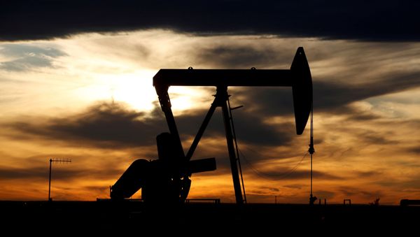 FILE PHOTO: the sun sets behind a crude oil pump jack on a drill pad in the Permian Basin in Loving County, Texas, U.S. November 24, 2019. Picture taken November 24, 2019 - Sputnik International
