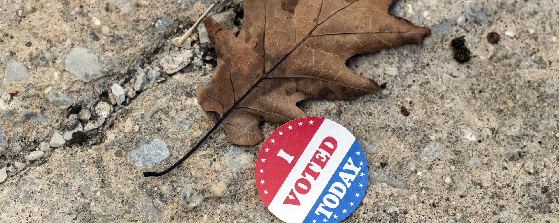 A discarded voting sticker lies on the ground at a satellite election office at Overbrook High School on Thursday, Oct. 1, 2020, in Philadelphia. The city of Philadelphia has opened several satellite election offices and more are slated to open in the coming weeks where voters can drop off their mail in ballots before Election Day.  - Sputnik International, 1920, 01.10.2022