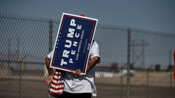 A woman holds a Trump Pence sign as she waits in line to attend the Great American Comeback Event campaign rally with US President Donald Trump at Xtreme Manufacturing in Henderson, Nevada on September 13, 2020 - Sputnik International