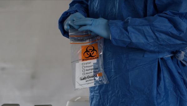 A biohazard bag is used for containing a specimen for a coronavirus disease (COVID-19) test A biohazard bag is used for containing a specimen for a coronavirus disease (COVID-19) test - Sputnik International