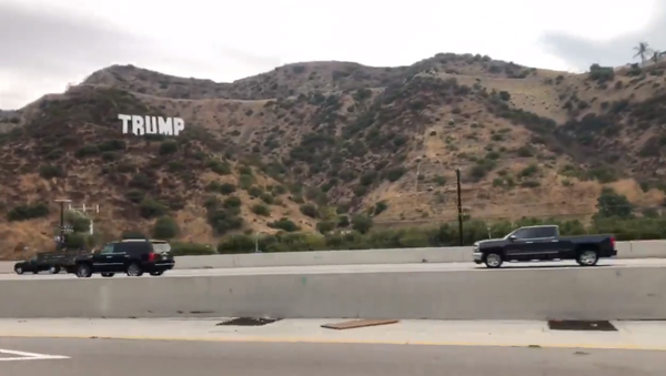 Screenshot from a video showing a Hollywood-style sign reading Trump erected above the 405 Freeway in California - Sputnik International
