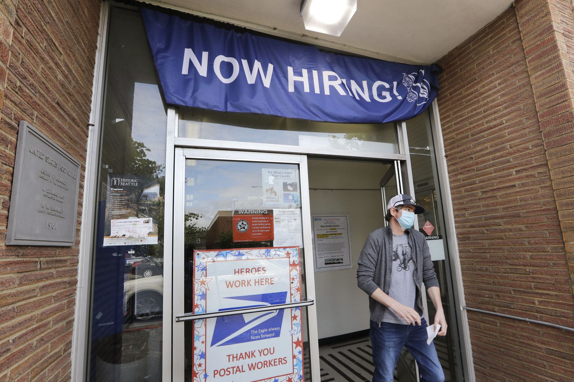 In this Thursday, June 4, 2020 file photo, a customer walks out of a U.S. Post Office branch and under a banner advertising a job opening, in Seattle. The job market took a big step toward healing in May 2020, though plenty of damage remains, as a record level of hiring followed record layoffs in March and April. The Labor Department reported Tuesday, July 7, 2020 that the number of available jobs rose sharply as well, but remained far below pre-pandemic levels. In this Thursday, June 4, 2020 file photo, a customer walks out of a U.S. Post Office branch and under a banner advertising a job opening, in Seattle. The job market took a big step toward healing in May 2020, though plenty of damage remains, as a record level of hiring followed record layoffs in March and April. The Labor Department reported Tuesday, July 7, 2020 that the number of available jobs rose sharply as well, but remained far below pre-pandemic levels. - Sputnik International, 1920, 07.09.2021