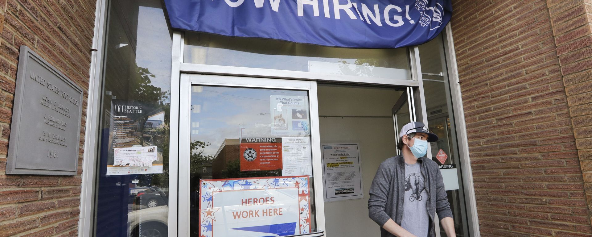 In this Thursday, June 4, 2020 file photo, a customer walks out of a U.S. Post Office branch and under a banner advertising a job opening, in Seattle. The job market took a big step toward healing in May 2020, though plenty of damage remains, as a record level of hiring followed record layoffs in March and April. The Labor Department reported Tuesday, July 7, 2020 that the number of available jobs rose sharply as well, but remained far below pre-pandemic levels. In this Thursday, June 4, 2020 file photo, a customer walks out of a U.S. Post Office branch and under a banner advertising a job opening, in Seattle. The job market took a big step toward healing in May 2020, though plenty of damage remains, as a record level of hiring followed record layoffs in March and April. The Labor Department reported Tuesday, July 7, 2020 that the number of available jobs rose sharply as well, but remained far below pre-pandemic levels. - Sputnik International, 1920, 18.02.2021