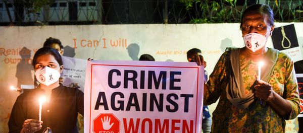 Lawyers display a placard to condemn the alleged gang-rape and murder of a low-caste teenaged woman in Uttar Pradesh state during a candlelight vigil in Ahmedabad on October 6, 2020. - Sputnik International