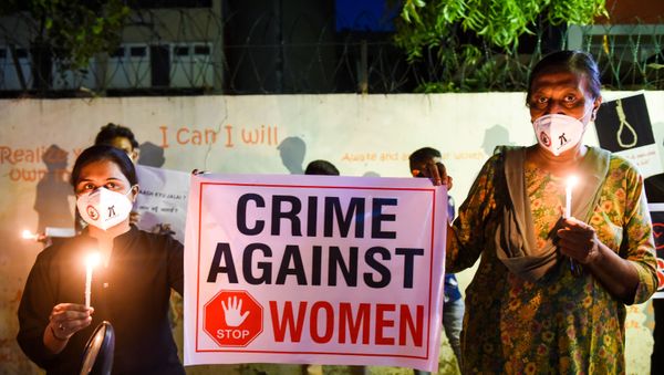 Lawyers display a placard to condemn the alleged gang-rape and murder of a low-caste teenaged woman in Uttar Pradesh state during a candlelight vigil in Ahmedabad on October 6, 2020. - Sputnik International