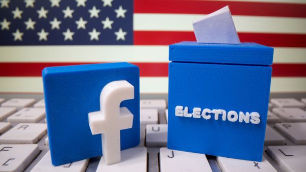 A 3D-printed elections box and Facebook logo are placed on a keyboard in front of U.S. flag in this illustration - Sputnik International