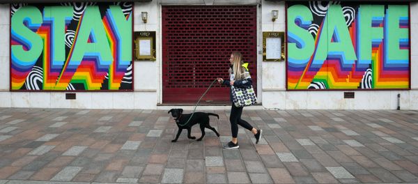 A pedestrian walks past a shuttered restaurant with a mural that reads Stay Safe on it in Glasgow on May 16, 2020, during the novel coronavirus COVID-19 pandemic lockdown - Sputnik International