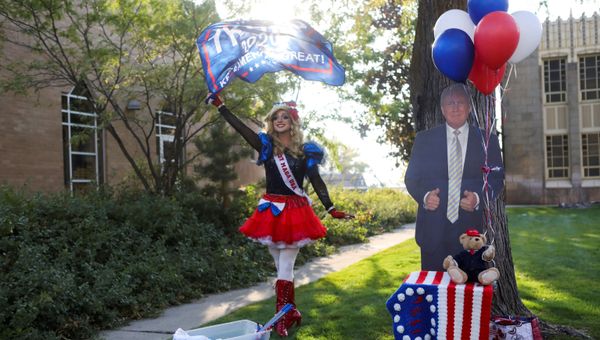U.S. President Donald Trump's supporter Lady MAGA USA walks waving a flag outside the site of the 2020 vice presidential debate between U.S. Vice President Mike Pence and Democratic vice presidential nominee and U.S. Senator Kamala Harris, at the campus of the University of Utah in Salt Lake City, Utah, U.S., October 7, 2020 - Sputnik International