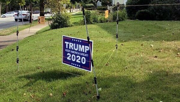 In this Sept. 14, 2020 photo, an electric fence surrounds a campaign sign for President Donald Trump in John Oliveira's yard in New Bedford, Mass. Oliveira said he installed the fence to protect his sign after several were stolen from his lawn during the summer.  - Sputnik International