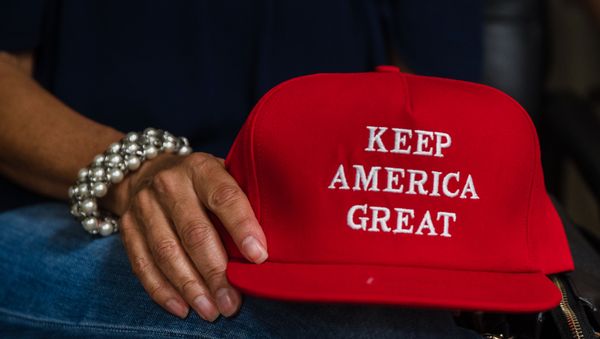 Deborah Palomba holds a Keep America Great hat as she watches US President Donald Trump acceptance speech for the Republican Party nomination for reelection during the final day of the Republican National Convention on TV in the office of San Diego County's Republican Party in Rancho Bernardo, California on August 27, 2020 - Sputnik International