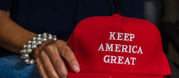 Deborah Palomba holds a Keep America Great hat as she watches US President Donald Trump acceptance speech for the Republican Party nomination for reelection during the final day of the Republican National Convention on TV in the office of San Diego County's Republican Party in Rancho Bernardo, California on August 27, 2020 - Sputnik International