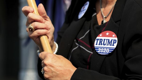 A view of a Trump button worn by a supporter, at the Hamilton County Board of Elections as people arrive to participate in early voting, Tuesday, Oct. 6, 2020, in Norwood, Ohio A view of a Trump button worn by a supporter, at the Hamilton County Board of Elections as people arrive to participate in early voting, Tuesday, Oct. 6, 2020, in Norwood, Ohio - Sputnik International