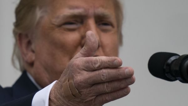 With two bandages on his hand, President Donald Trump gestures while speaking from the Blue Room Balcony of the White House to a crowd of supporters, Saturday, Oct. 10, 2020, in Washington.  - Sputnik International