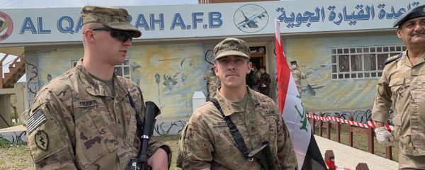 U.S. soldiers stand guard during the hand over ceremony of Qayyarah Airfield, Iraqi Security Forces, in the south of Mosul, Iraq  early Friday, March 27, 2020. Iraq's military on Thursday said at least two rockets hit inside Baghdad's heavily fortified Green Zone, the seat of Iraq's government and home to the American Embassy, in the first attack following a brief lull in violence from earlier this month.  - Sputnik International