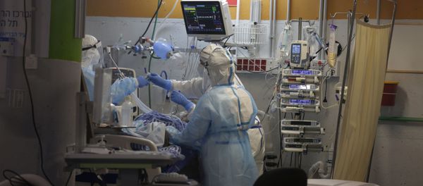 Medical professionals in full protective equipment tend to an elderly man on a ventilator in the critical care coronavirus unit, which was built in an underground parking garage at Sheba Medical center in Ramat Gan, Israel, Wednesday, Sept. 30, 2020, amid a spike in COVID-19 cases. Medical professionals in full protective equipment tend to an elderly man on a ventilator in the critical care coronavirus unit, which was built in an underground parking garage at Sheba Medical center in Ramat Gan, Israel, Wednesday, Sept. 30, 2020, amid a spike in COVID-19 cases. - Sputnik International