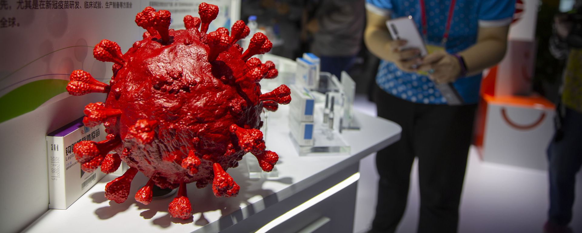 A visitor wearing a face mask takes a photo of a model of a coronavirus and boxes for COVID-19 vaccines at a display by Chinese pharmaceutical firm Sinopharm at the China International Fair for Trade in Services (CIFTIS) in Beijing, Saturday, Sept. 5, 2020. With the COVID-19 pandemic largely under control, China's capital on Saturday kicked off one of the first large-scale public events since the start of the coronavirus outbreak, as tens of thousands of attendees were expected to visit displays from nearly 2,000 Chinese and foreign companies showcasing their products and services. A visitor wearing a face mask takes a photo of a model of a coronavirus and boxes for COVID-19 vaccines at a display by Chinese pharmaceutical firm Sinopharm at the China International Fair for Trade in Services (CIFTIS) in Beijing, Saturday, Sept. 5, 2020. With the COVID-19 pandemic largely under control, China's capital on Saturday kicked off one of the first large-scale public events since the start of the coronavirus outbreak, as tens of thousands of attendees were expected to visit displays from nearly 2,000 Chinese and foreign companies showcasing their products and services. - Sputnik International, 1920, 27.02.2023