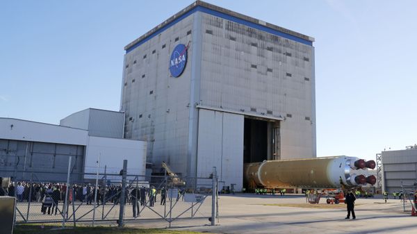 Employees and contractors watch as the core stage of NASA's Space Launch System rocket, that will be used for the Artemis 1 Mission, is rolled out of the NASA Michoud Assembly Facility where it was built, in New Orleans, Wednesday, Jan. 8, 2020. - Sputnik International