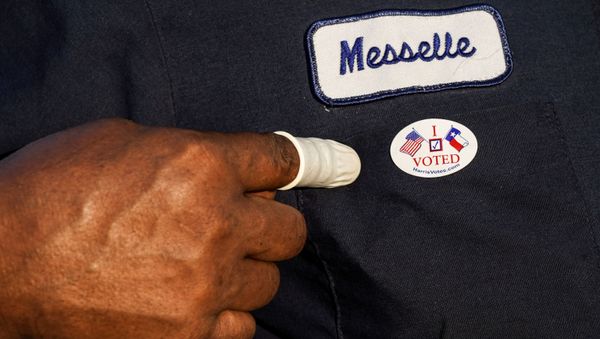 A person wearing a finger sack points at an I Voted sticker after casting ballot for the upcoming presidential election as early voting begins in Houston, Texas, U.S., October 13, 2020. - Sputnik International