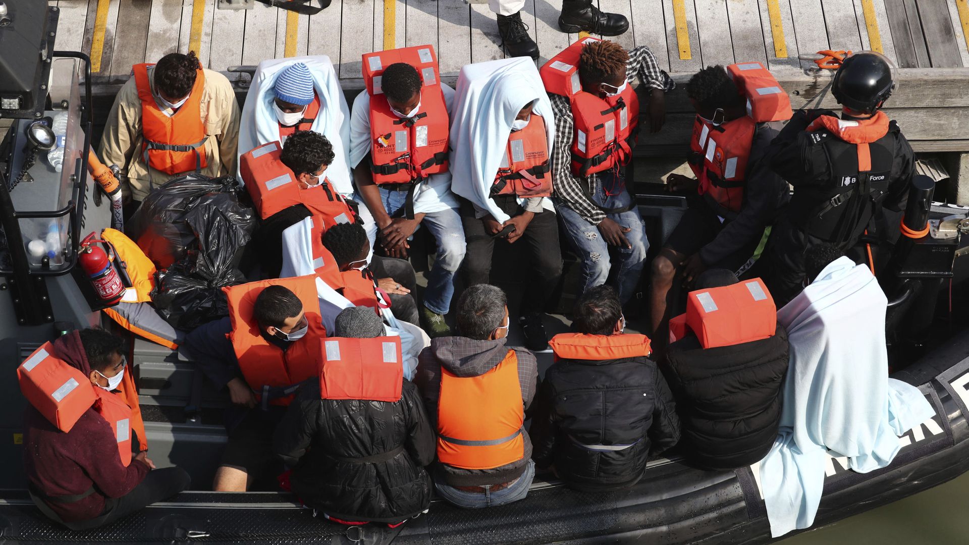 A group of people, thought to be migrants wait on a Border Force rib to come ashore at Dover marina in Kent, England after a small boat incident in the English Channel, Tuesday Sept. 22, 2020. A group of people, thought to be migrants wait on a Border Force rib to come ashore at Dover marina in Kent, England after a small boat incident in the English Channel, Tuesday Sept. 22, 2020. - Sputnik International, 1920, 05.06.2021