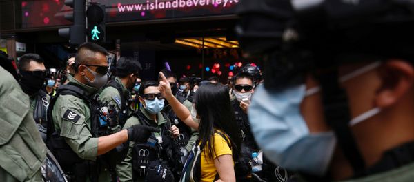 A pro-democracy protester argues with police before a protest urging the release of twelve Hong Kong activists, detained on the Chinese mainland, who were arrested at sea after attempting to flee to Taiwan, on Chinese National Day in Hong Kong, China October 1, 2020. A pro-democracy protester argues with police before a protest urging the release of twelve Hong Kong activists, detained on the Chinese mainland, who were arrested at sea after attempting to flee to Taiwan, on Chinese National Day in Hong Kong, China October 1, 2020. - Sputnik International