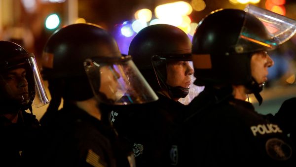 Police officers watch demonstrators as they continue to protest after the not guilty verdict in the murder trial of Jason Stockley, a former St. Louis police officer, charged with the 2011 shooting of Anthony Lamar Smith, who was Black, in St. Louis, Missouri, U.S., September 17, 2017. Police officers watch demonstrators as they continue to protest after the not guilty verdict in the murder trial of Jason Stockley, a former St. Louis police officer, charged with the 2011 shooting of Anthony Lamar Smith, who was Black, in St. Louis, Missouri, U.S., September 17, 2017. - Sputnik International