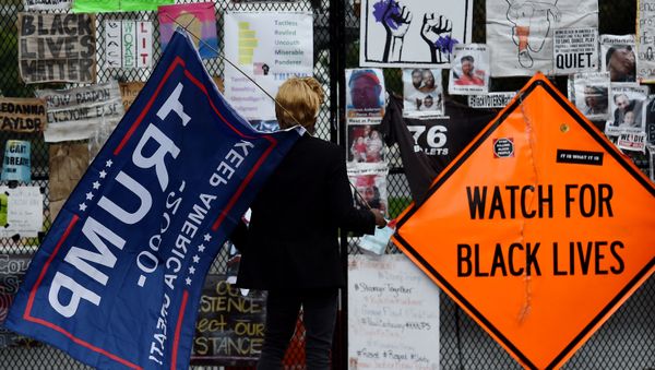 A supporter of US President Donald Trump arrives at Black Lives Matter Plaza in Washington, DC, on 10 October 2020, before a speech by the American President at the White House. - Sputnik International
