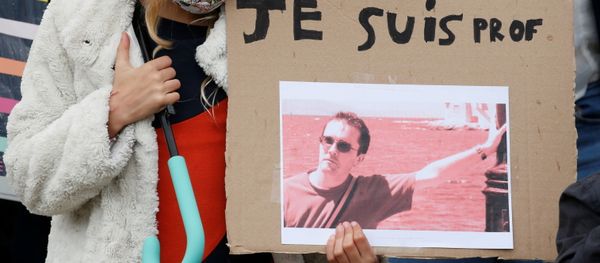 A girl holds a banner with a picture of Samuel Paty, the French teacher who was beheaded on the streets of the Paris suburb of Conflans St Honorine, during a tribute at the Place de la Republique, in Lille, France, October 18, 2020. REUTERS/Pascal Rossignol NO RESALES. NO ARCHIVES. A girl holds a banner with a picture of Samuel Paty, the French teacher who was beheaded on the streets of the Paris suburb of Conflans St Honorine, during a tribute at the Place de la Republique, in Lille, France, October 18, 2020. REUTERS/Pascal Rossignol NO RESALES. NO ARCHIVES. - Sputnik International