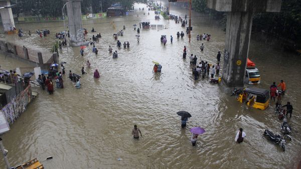 People wade through a flooded road in Chennai, Tamil Nadu, India, Wednesday, Dec. 2, 2015 - Sputnik International
