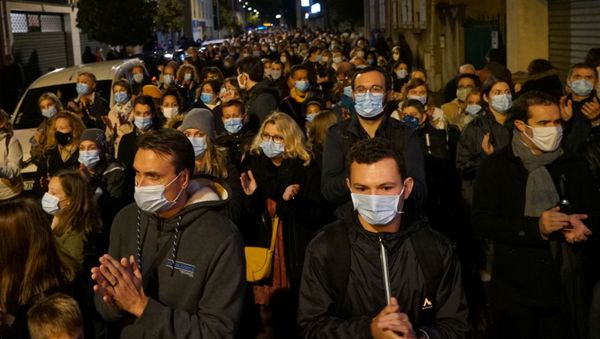 People attend a silent march to pay tribute to Samuel Paty, the French teacher who was beheaded on the streets of the Paris suburb of Conflans-Sainte-Honorine, France, 20 October 2020 - Sputnik International