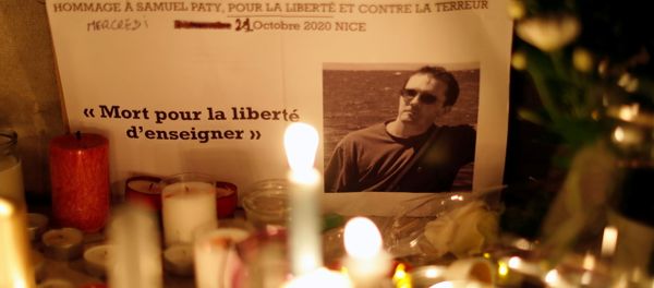 Candles are lit at a makeshift memorial as people gather to pay homage to Samuel Paty, the French teacher who was beheaded on the streets of the Paris suburb of Conflans-Sainte-Honorine, as part of a national tribute, in Nice, France, October 21, 2020 Candles are lit at a makeshift memorial as people gather to pay homage to Samuel Paty, the French teacher who was beheaded on the streets of the Paris suburb of Conflans-Sainte-Honorine, as part of a national tribute, in Nice, France, October 21, 2020 - Sputnik International