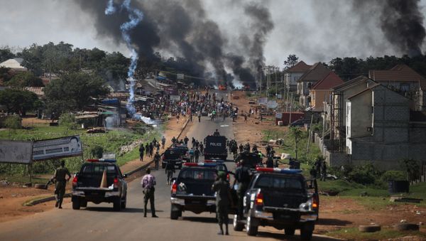 Nigerian Police fire teargas at people during clashes between youths in Apo, Abuja, Nigeria, on October 20, 2020, following the ongoing demonstrations against the unjustly brutality of the Nigerian Police Force Unit, the Special Anti-Robbery Squad (SARS).  - Sputnik International