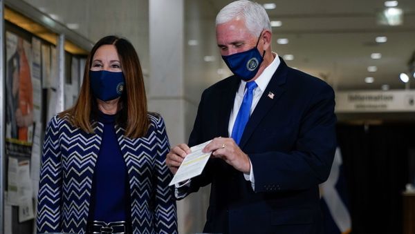 U.S. Vice President Mike Pence, stands with his wife, Karen, while casting his ballot for the upcoming election at a polling station in Indianapolis, Indiana, U.S. October 23, 2020 - Sputnik International