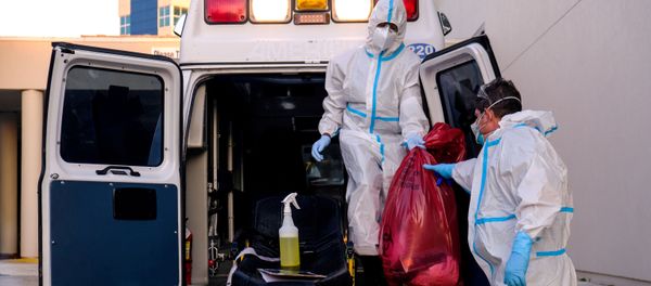 EMTs cleanse their materials outside Memorial West Hospital where coronavirus disease (COVID-19) patients are treated, in Pembroke Pines, Florida, U.S. July 13, 2020. EMTs cleanse their materials outside Memorial West Hospital where coronavirus disease (COVID-19) patients are treated, in Pembroke Pines, Florida, U.S. July 13, 2020. - Sputnik International