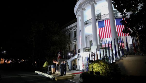 Judge Amy Coney Barrett is sworn in as an associate justice of the U.S. Supreme Court by Supreme Court Justice Clarence Thomas as President Donald Trump and her husband Jesse Barrett watch on the South Lawn of the White House in Washington, U.S., October 26, 2020. - Sputnik International