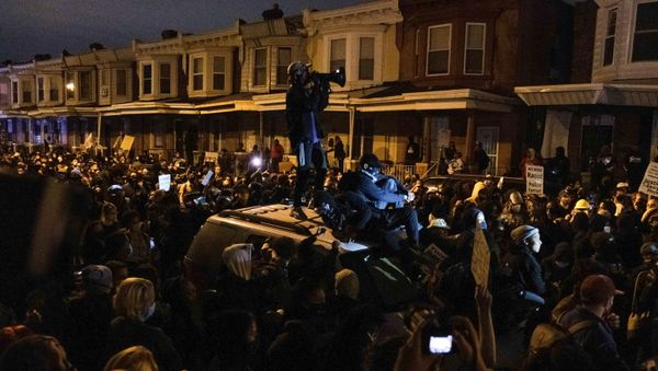 A protester stands on a vehicle as demonstrators clash with riot police during a rally after the death of Walter Wallace Jr., a black man who was shot by police in Philadelphia, Pennsylvania, 27 October 2020.  - Sputnik International
