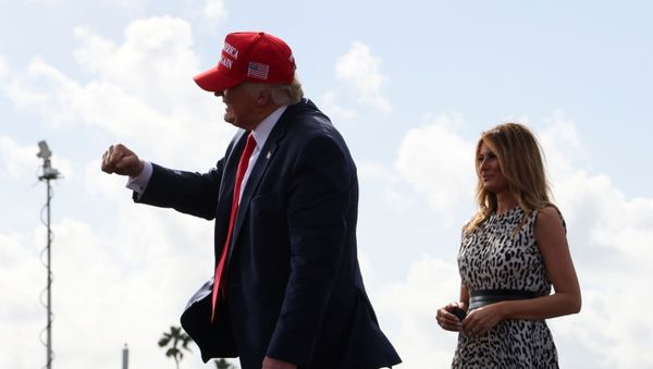 U.S. President Donald Trump makes a fist as first lady Melania Trump looks on during his campaign rally outside Raymond James Stadium, in Tampa, Florida, U.S., October 29, 2020 - Sputnik International