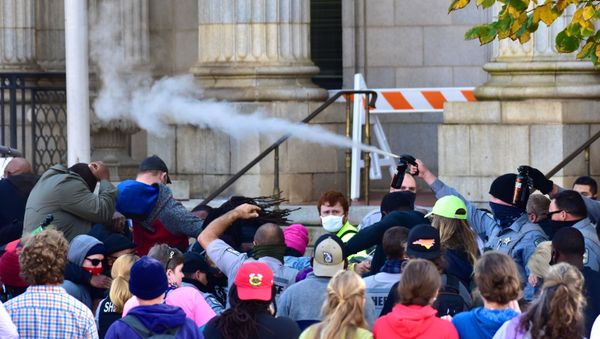 Law enforcement officers spray protesters shortly after a moment of silence during a Get Out The Vote march in Graham, North Carolina, U.S. October 31, 2020. Law enforcement officers spray protesters shortly after a moment of silence during a Get Out The Vote march in Graham, North Carolina, U.S. October 31, 2020. - Sputnik International