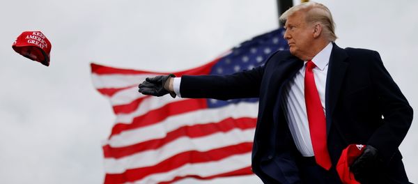 U.S. President Donald Trump tosses out Make America Great Again (MAGA) caps as he arrives for a campaign rally at Oakland County International Airport in Waterford Township, Michigan, U.S., October 30, 2020. REUTERS/Carlos Barria U.S. President Donald Trump tosses out Make America Great Again (MAGA) caps as he arrives for a campaign rally at Oakland County International Airport in Waterford Township, Michigan, U.S., October 30, 2020. REUTERS/Carlos Barria - Sputnik International