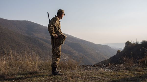An armed man is pictured in the area of the Lachin corridor, the self-proclaimed Nagorno-Karabakh Republic - Sputnik International