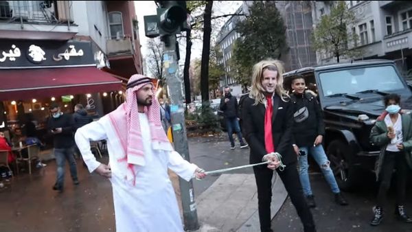 German YouTuber of Syrian origin, Fayez Kanfash, drags another person dressed as French President Emmanuel Macron through the streets of Berlin German YouTuber of Syrian origin, Fayez Kanfash, drags another person dressed as French President Emmanuel Macron through the streets of Berlin - Sputnik International